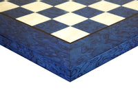 Close-up of a blue Erable and Elm wood luxury chess board with high gloss lacquer finish and intricate burl grain pattern.