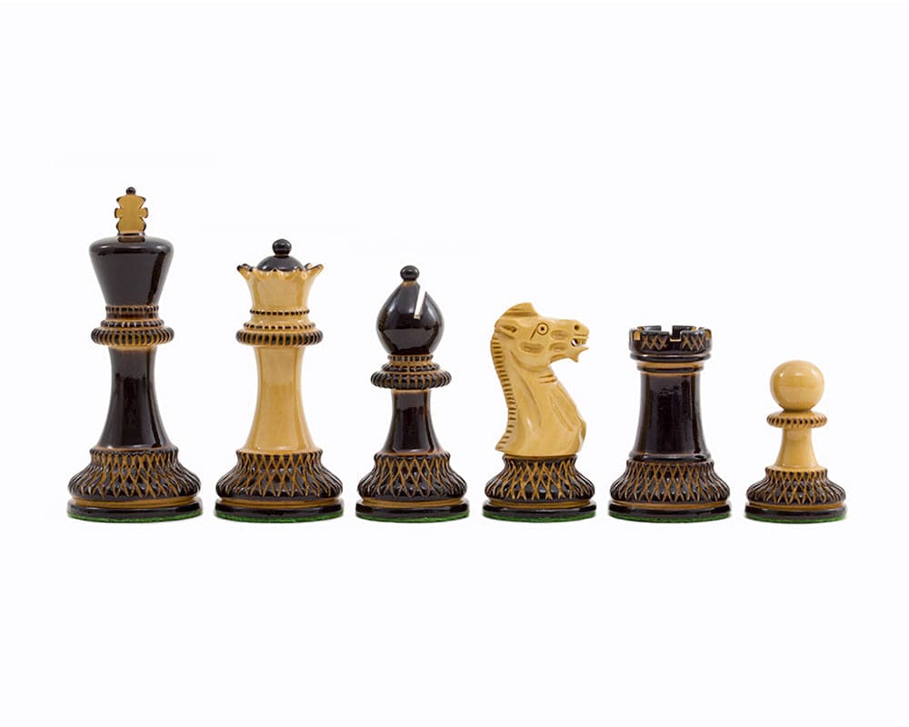 Burnt Parker Chessmen 4 inch Staunton style boxwood pieces with intricate carving and contrasting dark and golden tones on white background