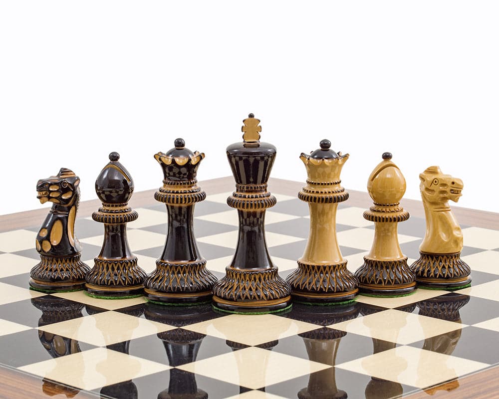 Burnt Parker Chessmen on chessboard, showing intricately carved Staunton-style pieces in dark and golden tones with a 4-inch king.