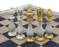 The San Severeo 24 Carat Gold and 990 Silver Plated Chessmen displayed on a chessboard