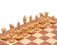 The Warwick Series 3 inch Ebonised Staunton Chessmen set on a wooden chessboard, displaying superb detail and classic design.