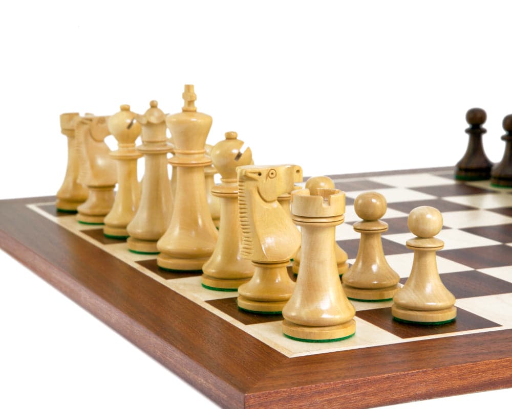 Traditional Staunton chess pieces on a wooden chessboard, expertly turned from boxwood and weighted for stability, featuring a 3 inch king.