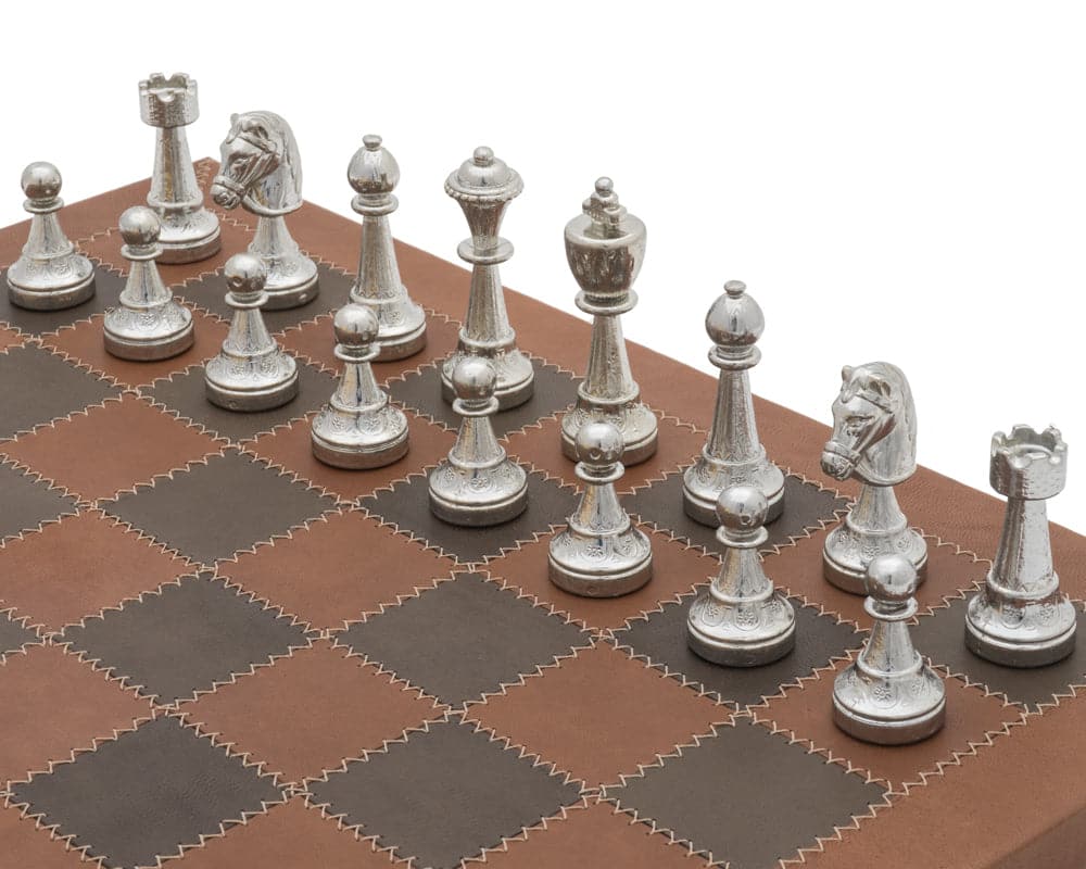 The Messina Gold and Silver Italian Leather Luxury Chess Set with detailed silver chess pieces on a brown leather board.