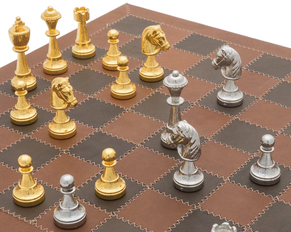 The Messina Gold and Silver Italian Leather Luxury Chess Set with intricate gold and silver pieces on a brown leather board.