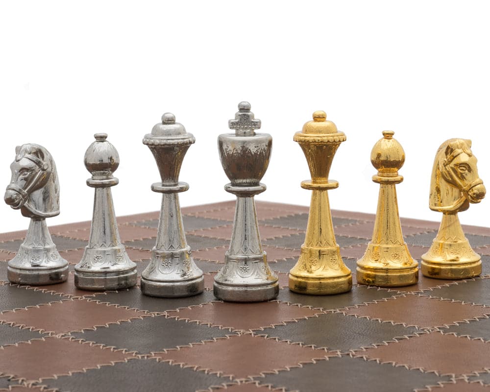 The Messina Gold and Silver Italian Leather Luxury Chess Set on leather chessboard.