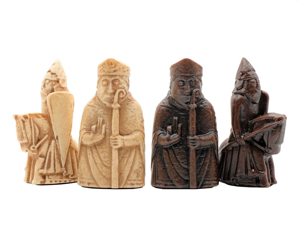 Isle of Lewis chessmen pieces showing detailed craftsmanship, beautifully shaped by Italian artisans, in ivory and brown tones.
